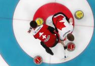 Curling - Pyeongchang 2018 Winter Olympics - Men's Bronze Medal Match - Switzerland v Canada - Gangneung Curling Center - Gangneung, South Korea - February 23, 2018 - Skip Peter de Cruz of Switzerland and vice-skip Marc Kennedy of Canada sweep. REUTERS/Cathal McNaughton