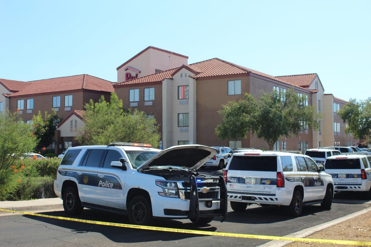 Phoenix Police Department vehicles and caution tape block off the entrance to Red Roof Inn near Interstate 17 and Bell Road on July 15, 2022, after a police shooting.