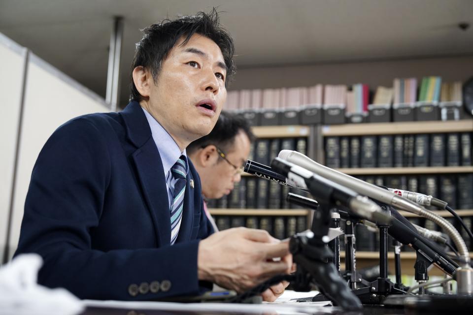 Lawyers of a claimant, Kazuyuki Minami, left, and Masafumi Yoshida, right, speak to media after the ruling of the Supreme Court Wednesday, Oct. 25, 2023, in Tokyo. Japan’s Supreme Court on Wednesday ruled that a law requiring transgender people to have sterilization surgery in order to officially change their gender is unconstitutional.(AP Photo/Eugene Hoshiko)