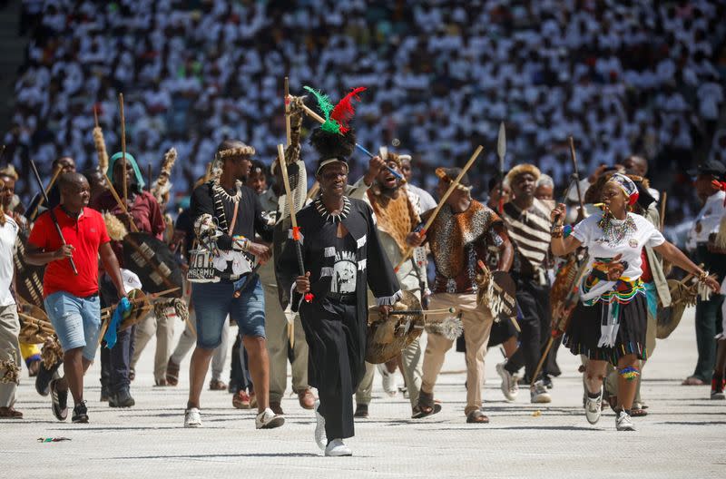 FILE PHOTO: Supporters of the Inkatha Freedom Party (IFP) march across a pitch at the Election Manifesto launch in Durban