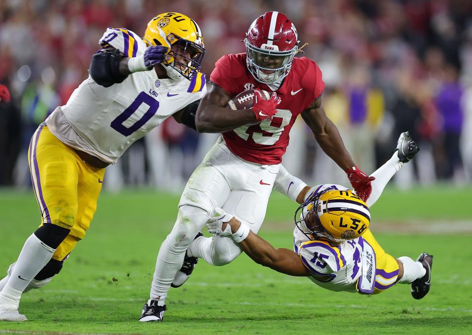 LSU defensive tackle Maason Smith (0), the Jaguars' second-round pick at No. 48 overall, tries to bring down Alabama receiver Kendrick Law in 2023 game.