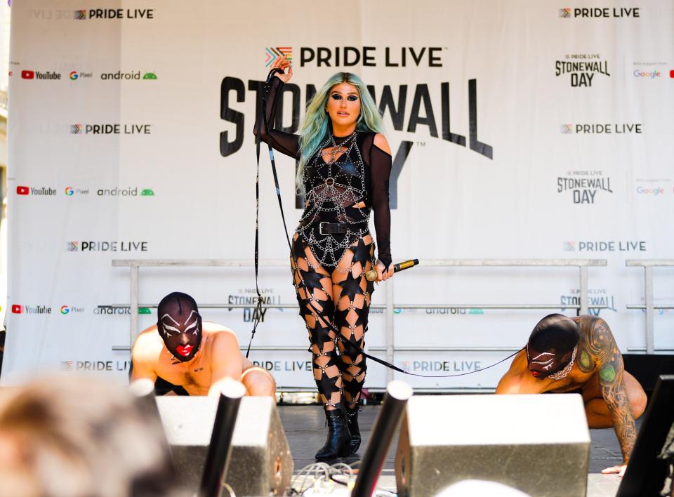 Kesha in a black leotard and star print pants on stage at Pride Live Stonewall Day