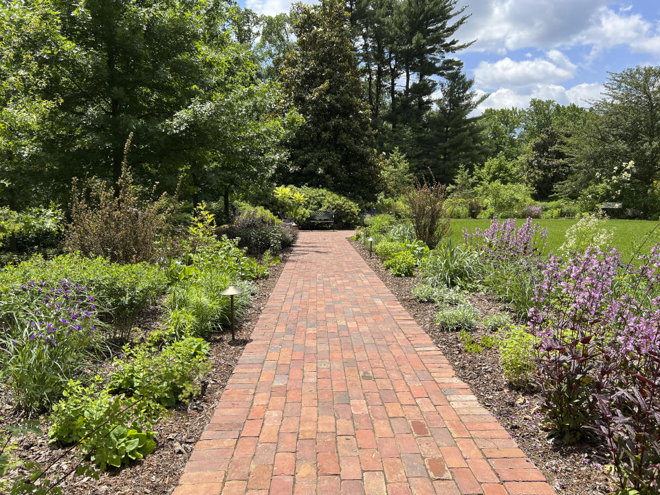 This undated photo provided by Mt. Cuba Center shows the Hockessin, Del. botanical garden's formal South Garden, planted entirely with native plants and cultivars of native plants, including: Penstemon, Thalictrum, Tradescantia, Liatris, Monarda, Amsonia, Artemesia, Baptisia, Eryngium, Physocarpus, Redbeckia, Solidago and Eryngium species. (Melissa Starkey/Mt. Cuba Center via AP)