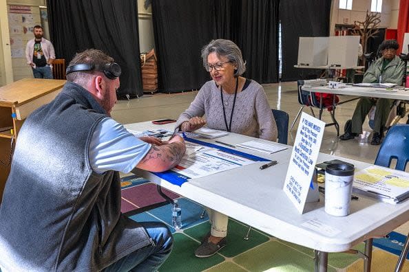 CHARLOTTE, NORTH CAROLINA - MARCH 5: Poll workers assist voters on Super Tuesday at the First Ward Creative Academy, Mecklenburg County Precinct 13 on March 5, 2024 in Charlotte, North Carolina. 15 States and one U.S. Territory hold their primary elections on Super Tuesday, awarding more delegates than any other day in the presidential nominating calendar.  (Photo by Grant Baldwin/Getty Images)