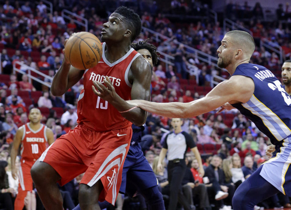 Houston Rockets center Clint Capela (15) is fouled as he goes for a shot by Memphis Grizzlies forward Chandler Parsons (25) during the second half of an NBA basketball game Saturday, Nov. 11, 2017, in Houston. (AP Photo/Michael Wyke)