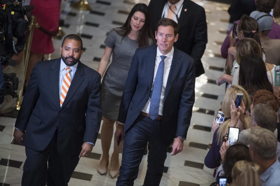 Jonathan Burks, Ashlee Strong and Brendan Buck, in single file, proceed over the marble tiles of the Capitol.