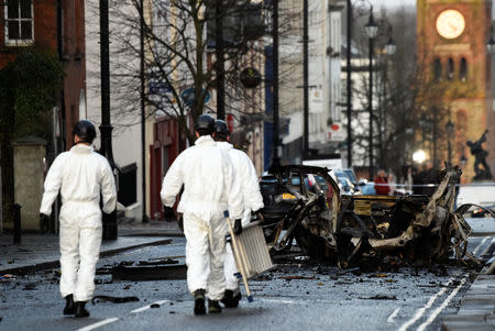 Forensic officers walk at the scene of a suspected car bomb in Londonderry, Northern Ireland January 20, 2019. REUTERS/Clodagh Kilcoyne