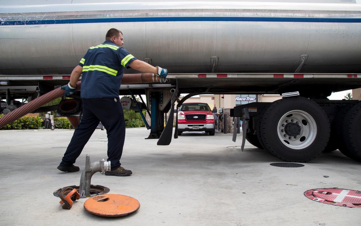Gas tanks are filled fuel at a RaceTrac station in Fort Myers as cars and trucks pull up to the pumps to refuel.
