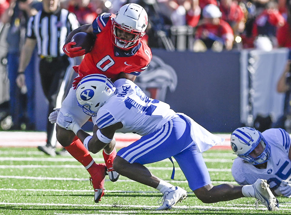 Liberty running back Dae Dae Hunter, left, protects the ball from BYU's Kaleb Hayes during an NCAA college football game, Saturday, Oct. 22, 2022, in Lynchburg, Va. (Paige Dingler/The News & Advance via AP)