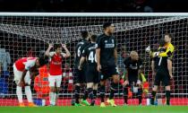 Football - Arsenal v Liverpool - Barclays Premier League - Emirates Stadium - 24/8/15 Liverpool's Simon Mignolet celebrates with James Milner and Martin SKrtel as Arsenal's Aaron Ramsey looks dejected Reuters / Eddie Keogh Livepic