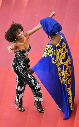 French actress and Miss France 2000 Sonia Rolland (l) is welcomed by Burundian singer and member of the Feature Film Jury Khadja Nin as hte protest gets underway