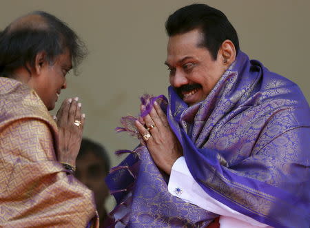Sri Lanka's former president Mahinda Rajapaksa, who is contesting in the upcoming general election, is blessed by a Hindu priest during the launch ceremony of his manifesto, in Colombo July 28, 2015. REUTERS/Dinuka Liyanawatte