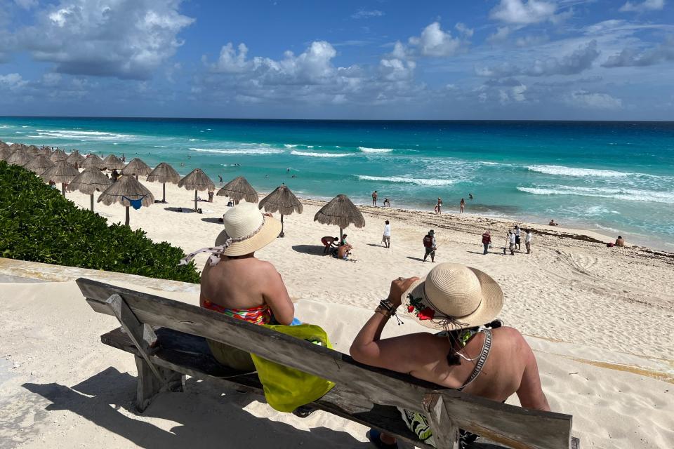 Women look at the sea in Playa Delfines (Dolphin Beach) in Cancun, Quintana Roo state, Mexico, on Nov. 8, 2022.