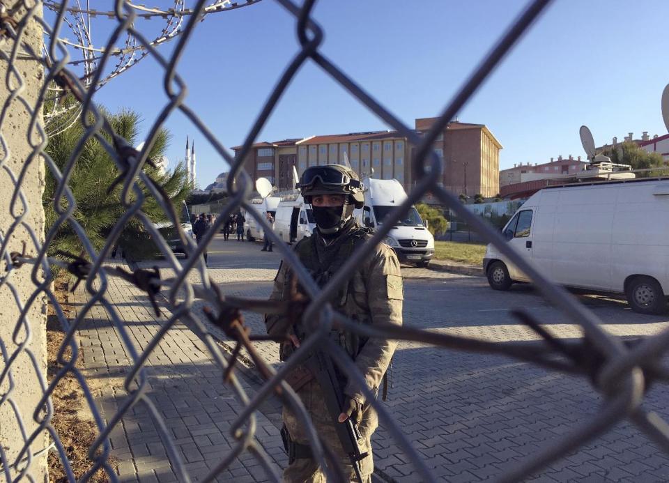 A paramilitary police officer stands at the entrance of Silivri Prison and Courthouse complex where 29 Turkish former police officers are on trial in the outskirts of Istanbul, Tuesday, Dec. 27, 2016. They are accused of aiding the failed military coup in July — the first trial over the attempt that led to some 270 deaths.(AP Photo/Mehmet Guzel)