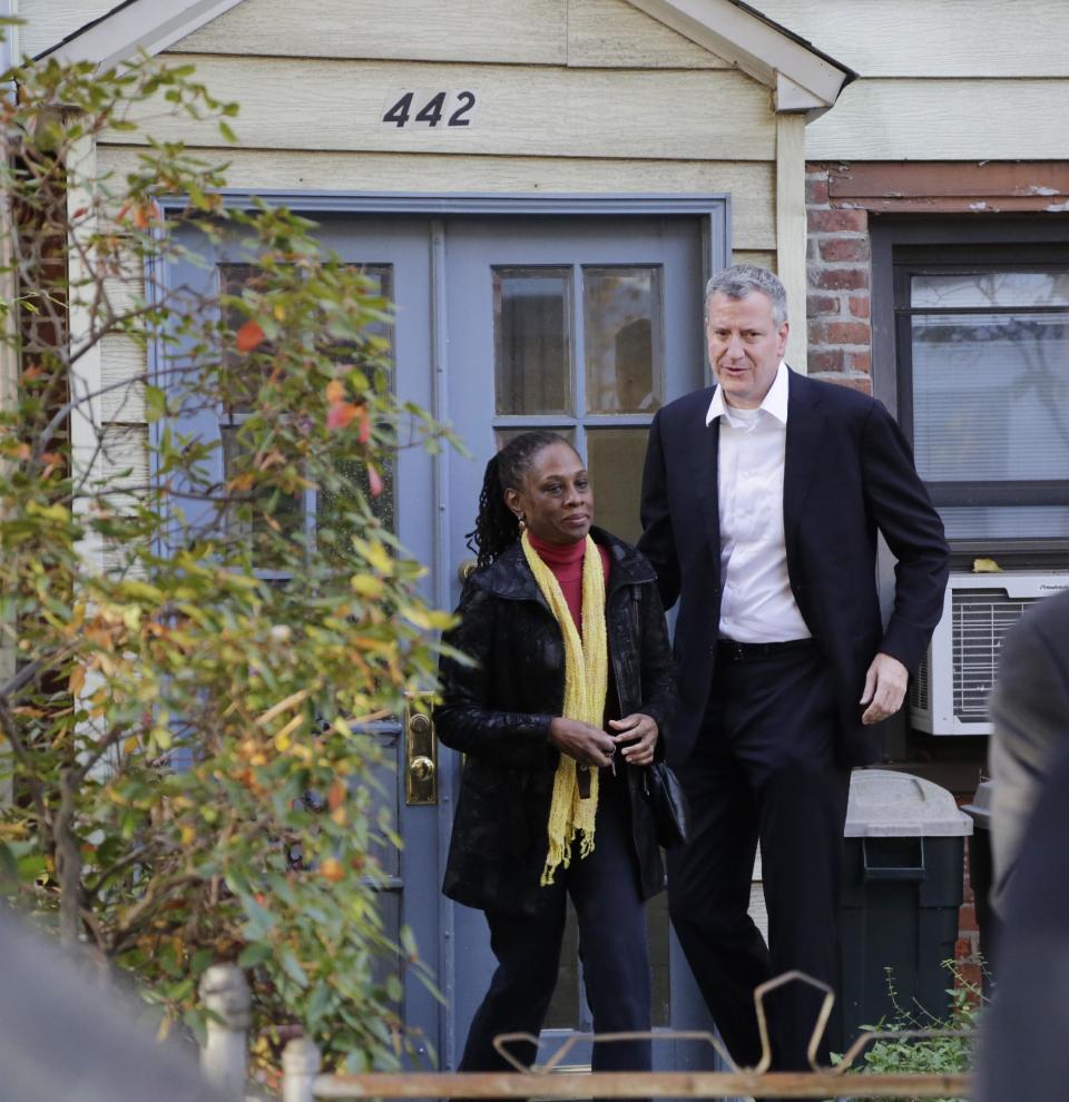 In this Nov. 6, 2013 photo, Chirlane McCray and her husband Bill de Blasio leave their house in the Park Slope neighborhood in the Brooklyn borough of New York. Now de Blasio faces a crucial early decision: should he leave Park Slope behind to move to the mayor’s official residence, stately Gracie Mansion on Manhattan’s Upper East Side? (AP Photo/Mark Lennihan)