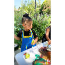 Stormi rocked an apron while painting during her "first day of preschool" with her cousins in September 2020.