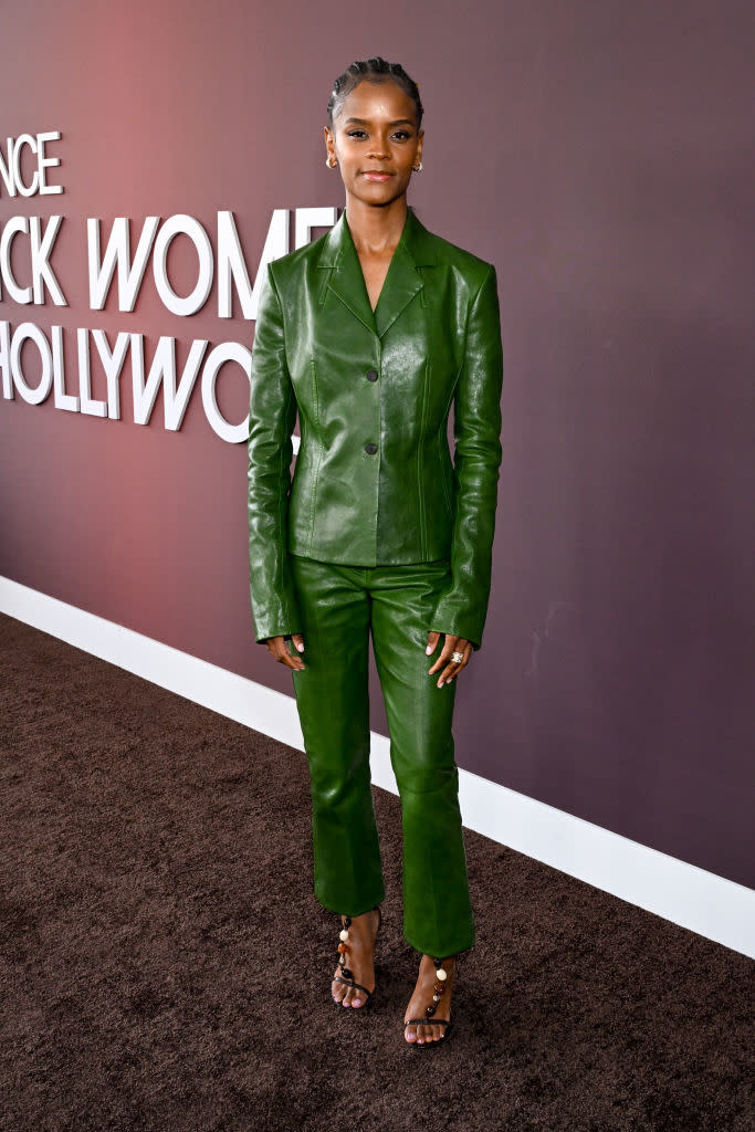 Letitia in a leather pantsuit poses on the red carpet