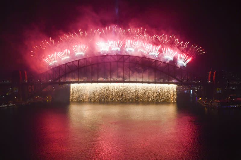 The midnight fireworks explode over the Sydney Harbour Bridge on Sydney Harbour during the Year's Eve celebrations in Sydney