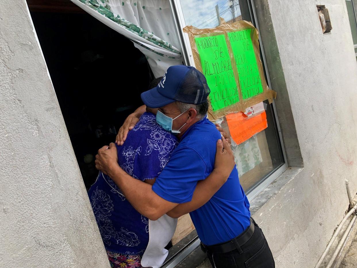 Pastor Lorenzo Ortiz greets one of the migrants staying at a shelter in Nuevo Laredo, Mexico. Ortiz worries that the return of the Remain in Mexico policy will put more migrants at risk.