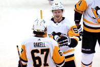 Pittsburgh Penguins' Jake Guentzel (59) celebrates his third goal of an NHL hockey game against the Boston Bruins during the third period in Pittsburgh, Thursday, April 21, 2022. (AP Photo/Gene J. Puskar)