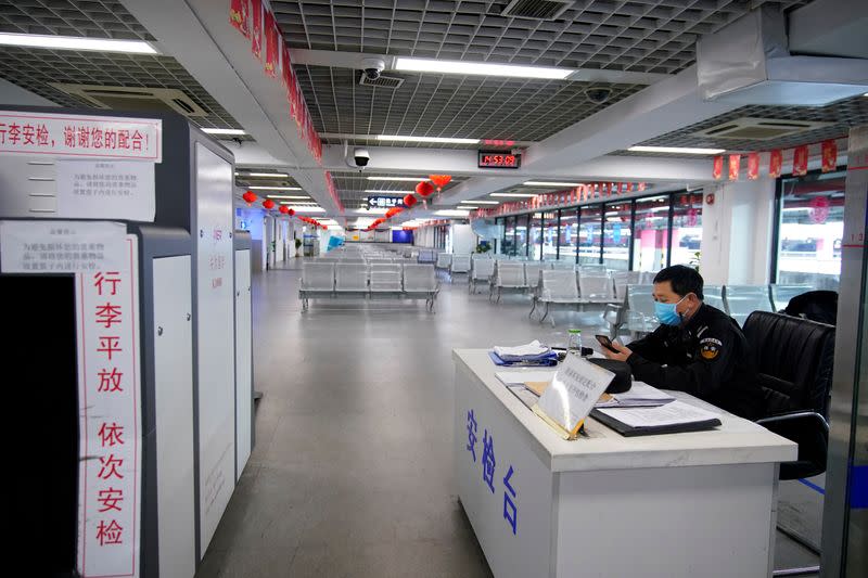 Staff member wears a mask at the closed Pudong International Airport Long Distance Bus Station in Shanghai