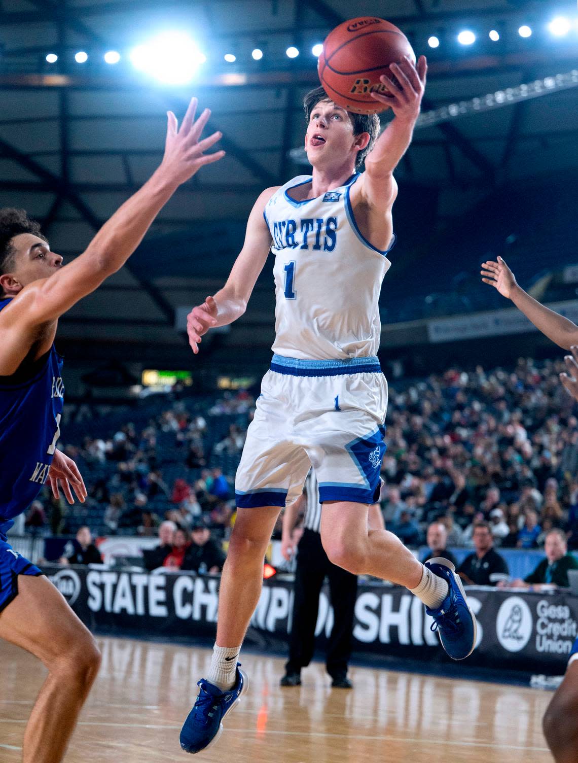 Curtis’ Tyce Paulsen flies to the hoop in front of Federal Way defender Dace Pleasant during their state semifinal game at the WIAA state basketball tournament in the Tacoma Dome in Tacoma, Washington, on Friday, March 3, 2023. Curtis won the game, 56-43.