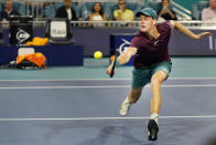 Jannik Sinner, of Italy, returns a shot from Carlos Alcaraz, of Spain, during the Miami Open tennis tournament, Friday, March 31, 2023, in Miami Gardens, Fla. (AP Photo/Wilfredo Lee)