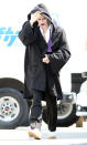 <p>Leto tries to hide his outfit on set in Toronto on June 10.</p>