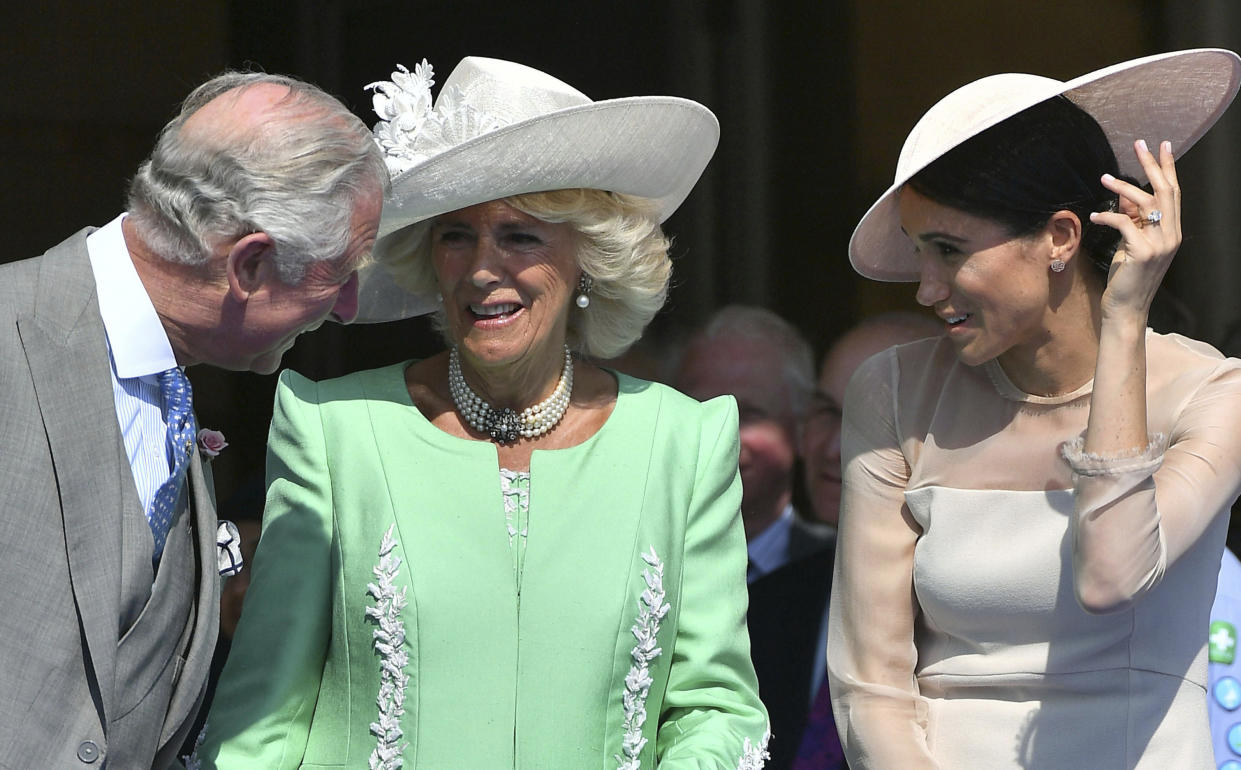 FILE - In this Tuesday, May 22, 2018 file photo, Britian's Prince Charles, left, speaks with Camilla, the Duchess of Cornwall and Meghan, the Duchess of Sussex, during a garden party at Buckingham Palace in London. King Charles III will hope to keep a lid on those tensions when his royally blended family joins as many as 2,800 guests for the new king’s coronation on May 6 at Westminster Abbey. All except Meghan, the Duchess of Sussex, who won’t be attending. (Dominic Lipinski/Pool Photo via AP, File)