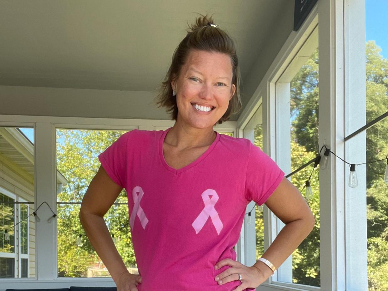 Rachel Garlinghouse wearing a pink breast cancer t shirt and smiling on her porch