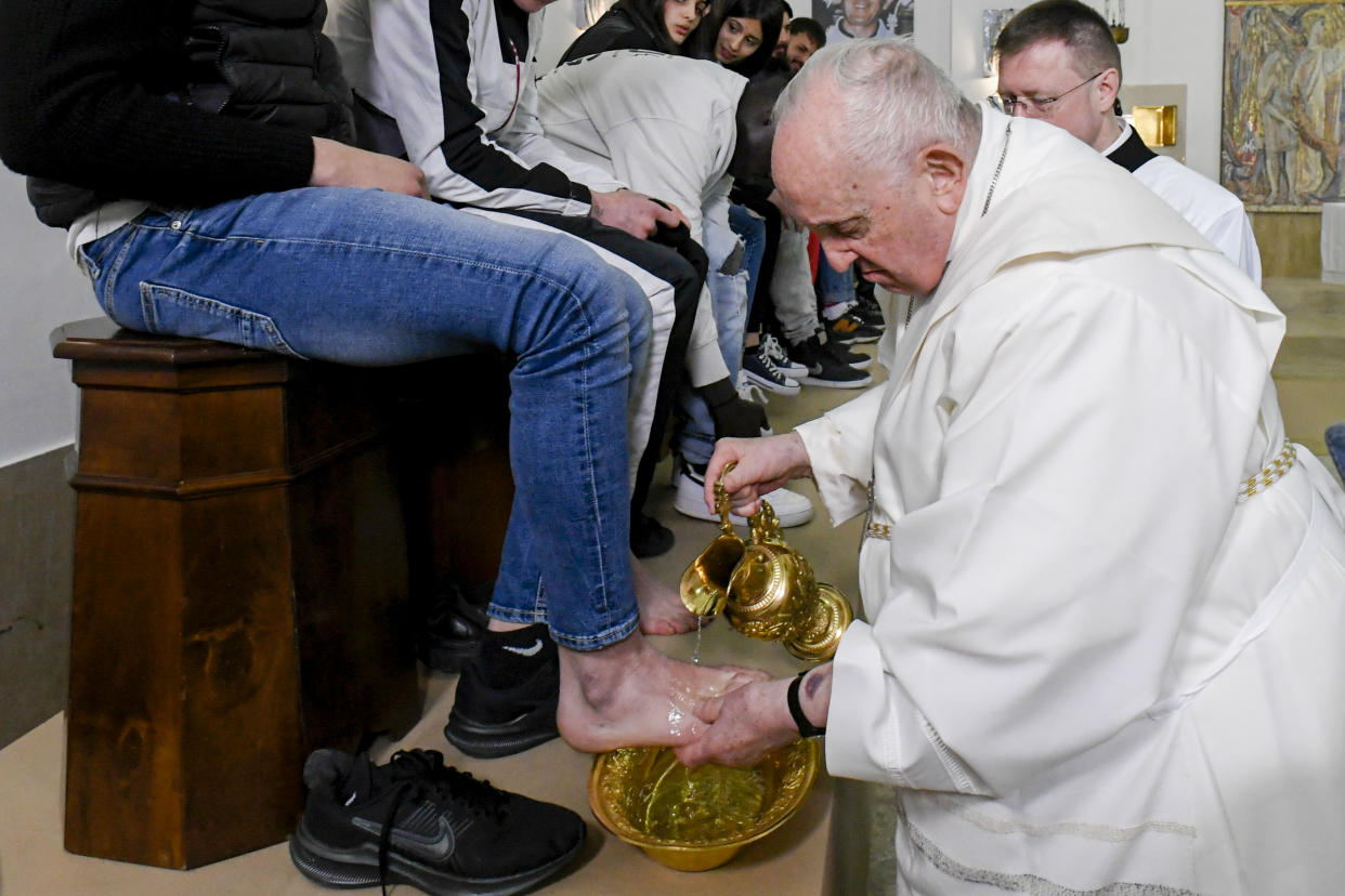 In this picture made available by Vatican Media Pope Francis washes the feet of the inmates of Rome's penitentiary of Casal del Marmo, Thursday, April 6, 2023. In a Holy Thursday ritual symbolizing humility, Pope Francis washed and wiped dry the bare feet of a dozen residents of a Rome juvenile prison, assuring them of their dignity and telling them "any of us" can fall into sin. (Vatican Media handout via AP)