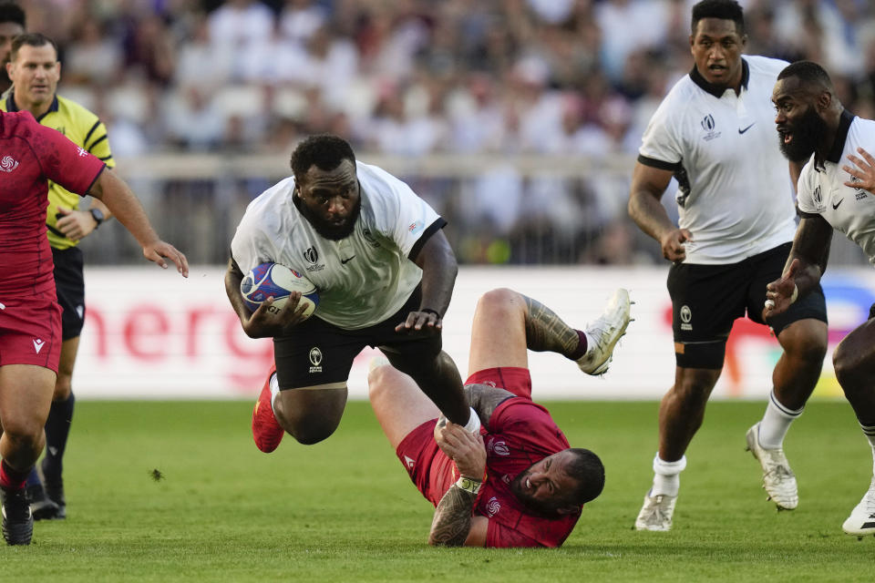 Fiji's Luke Tagi is tackled by Georgia's Beka Gigashvili during the Rugby World Cup Pool C match between Fiji and Georgia at the Stade de Bordeaux in Bordeaux, France, Saturday, Sept. 30, 2023. (AP Photo/Thibault Camus)