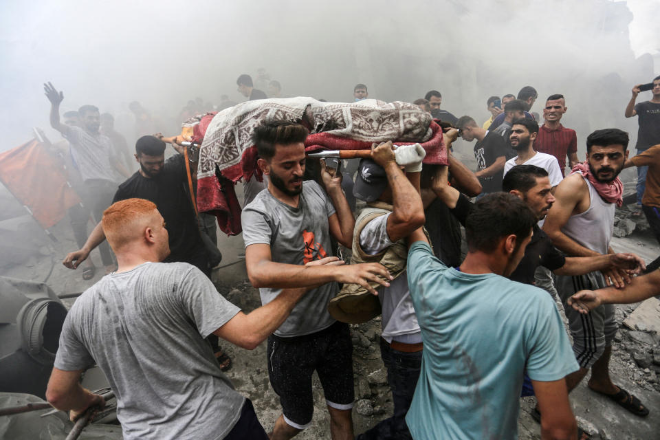 People remove the body of a Palestinian killed in an airstrikes on the Jabalia refugee camp in the northern Gaza Strip on Monday. (Mahmoud Issa/Reuters)