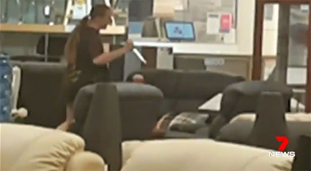 This woman was filmed stabbing a lounge chair inside a Harvey Norman store. Photo: 7 News