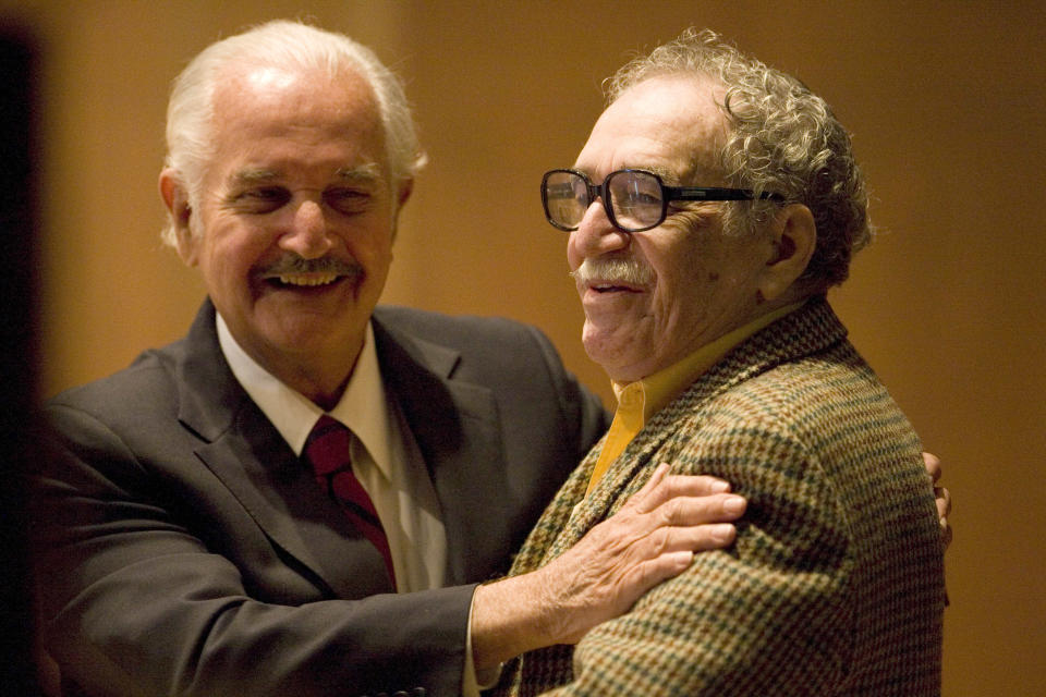 FILE - In this Nov. 18, 2008 file photo, Mexican writer Carlos Fuentes, left, embraces Colombian author Gabriel Garcia Marquez during a round table discussion on Fuentes' work at the UNAM national university in Mexico City. Marquez died Thursday April 17, 2014 at his home in Mexico City. (AP Photo/Dario Lopez-Mills, File)