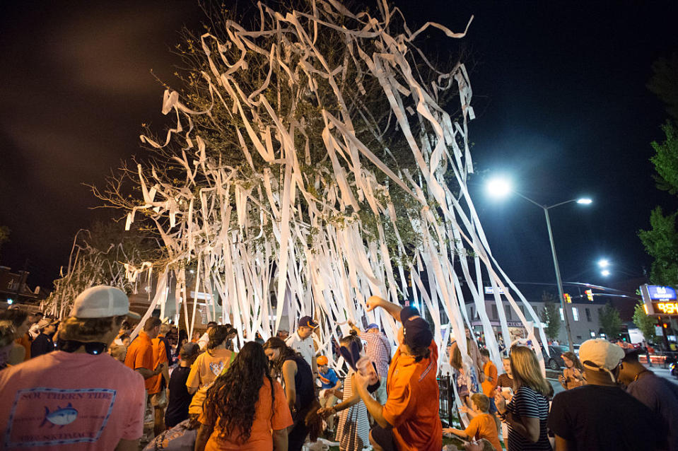 AUBURN, AL - SEPTEMBER 10: Fans of the Auburn Tigers roll trees at Toomer's Corner after defeating the Arkansas State Red Wolves at Jordan Hare Stadium on September 10, 2016 in Auburn, Alabama. The Auburn Tigers defeated the Arkansas State Red Wolves 51-14.(Photo by Michael Chang/Getty Images)