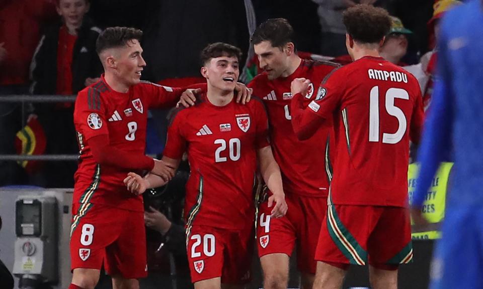 <span>Daniel James (centre) is congratulated by teammates after scoring Wales’ fourth goal in the 86th minute.</span><span>Photograph: Geoff Caddick/AFP/Getty Images</span>