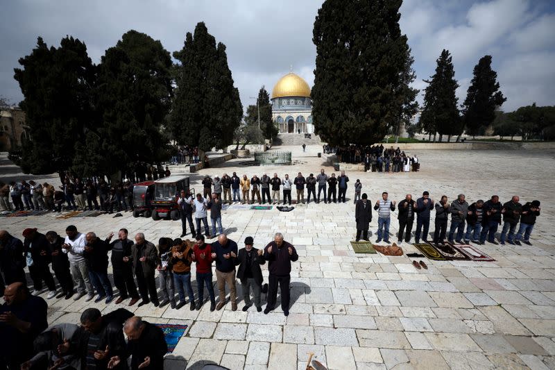 FILE PHOTO: Worshippers pray as the Dome of the Rock is seen in the background in Jerusalem's Old City