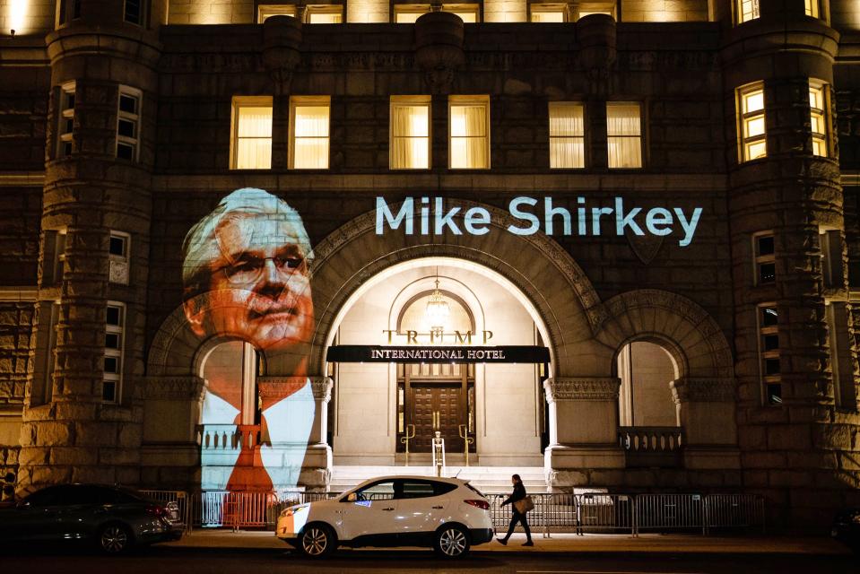 Projections of messages to Republican election officials from Michigan Senate Majority Leader Mike Shirkey and Speaker of the House Lee Chatfield during their visit to the White House light up the front of the Trump Hotel in Washington, D.C.