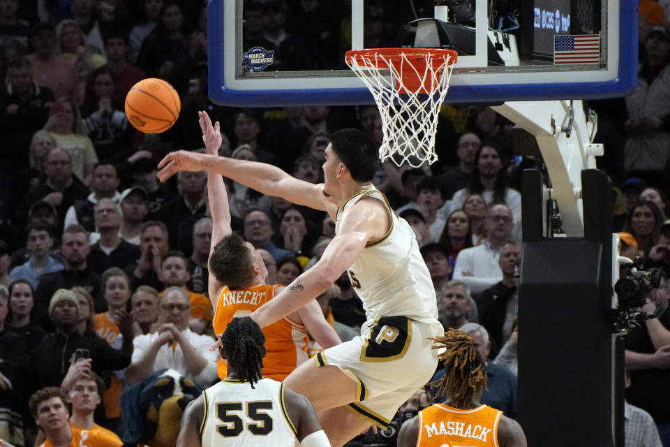 Purdue center Zach Edey (15) blocks a shot byTennessee guard Dalton Knecht (3) during the second half of an Elite Eight college basketball game in the NCAA Tournament, Sunday, March 31, 2024, in Detroit. (AP Photo/Paul Sancya)