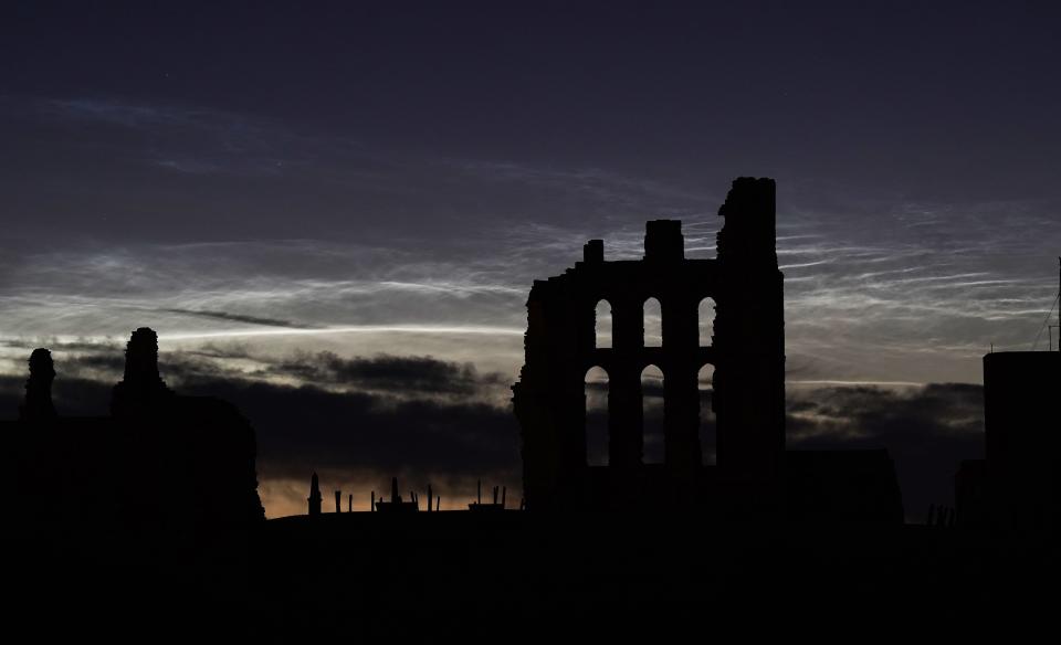 Noctilucent clouds over Tynemouth Priory and Castle in England.