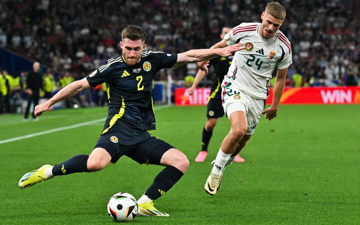 Scotland's defender #02 Anthony Ralston (L) fights for the ball with Hungary's defender #24 Marton Dardai