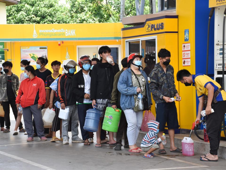 Citizens queue up for fuel at a petrol station in Vientiane, Laos on May 14, 2022.