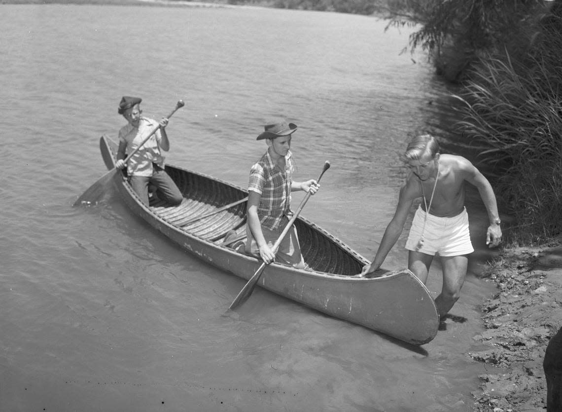 July 26, 1944: Charles Crabtree, right, waterfront director, instructs Danny Wier, left, son of Mrs. Mable McKinney Weir, and Bob Riedel (middle), son of Mr. and Mrs. A.F. Riedel, in canoeing. Fort Worth Star-Telegram archive/UT Arlington Special Collections