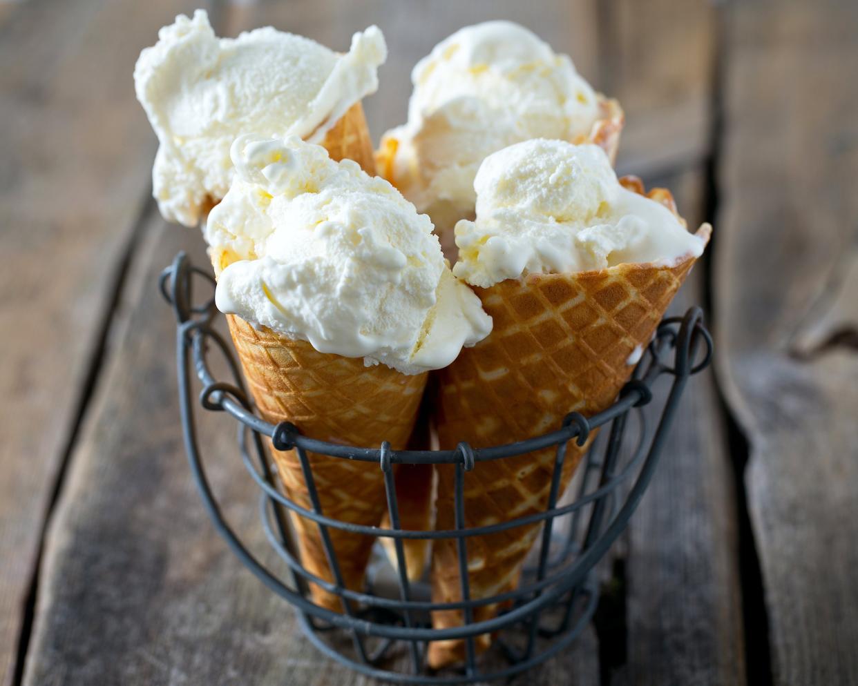 vanilla ice cream cones on wooden surface