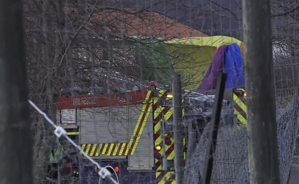 In this image made from video, rescue crews tend to a hot air balloon crash near Arrowtown, New Zealand, Friday, July 9, 2021. The balloon crashed as it was about to land on Friday, injuring all 11 people on board, including two who suffered serious injuries and were airlifted to a hospital, according to authorities and the ballooning company. (TVNZ via AP)