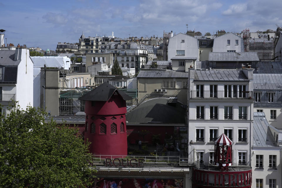 The Moulin Rouge (Red Mill) is seen Thursday, April 25, 2024 in Paris. The windmill from the Moulin Rouge, the 19th century Parisian cabaret, has fallen off the roof overnight along with some of the letters in its name. (AP Photo/Thibault Camus)