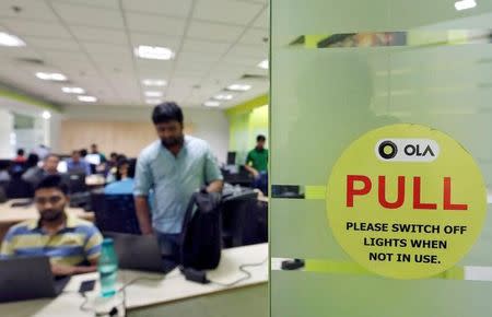 Employees work inside the office of Ola cab service in Gurugram, previously known as Gurgaon, New Delhi, April 20, 2016. REUTERS/Anindito Mukherjee