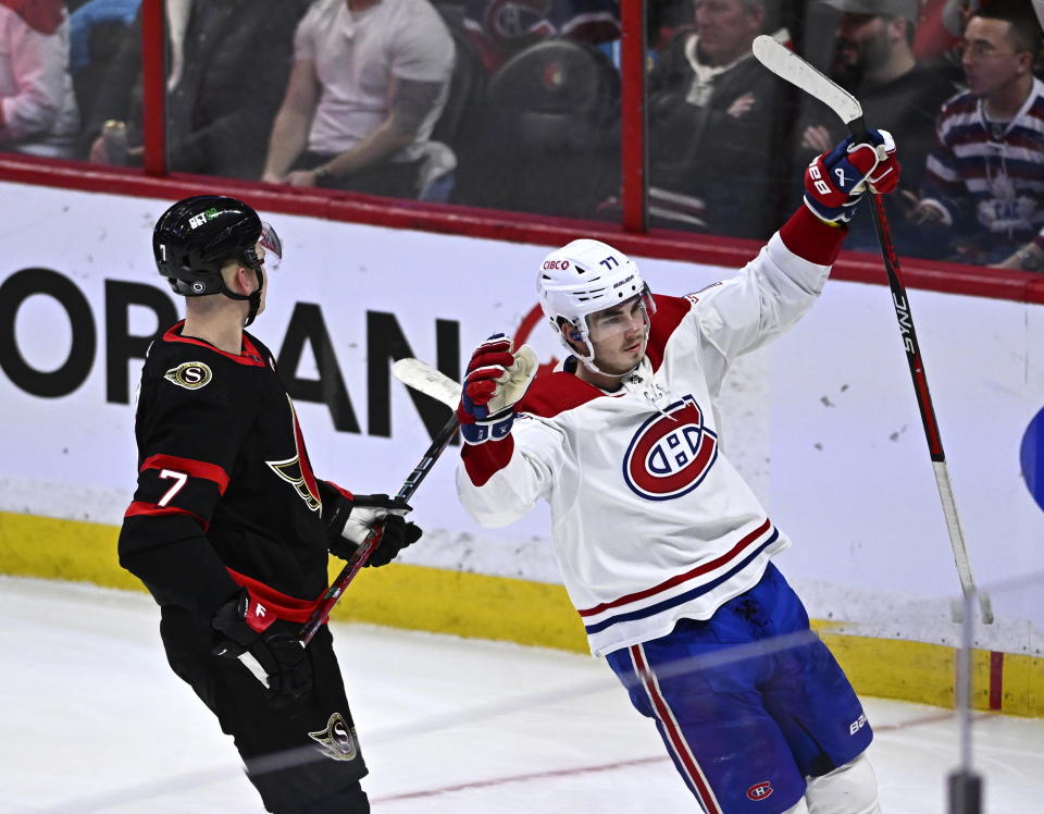 Montreal Canadiens center Kirby Dach (77) celebrates his goal in front of Ottawa Senators left wing Brady Tkachuk (7) during the third period of an NHL hockey game in Ottawa, Ontario on Wednesday, Dec. 14, 2022. (Justin Tang/The Canadian Press via AP)