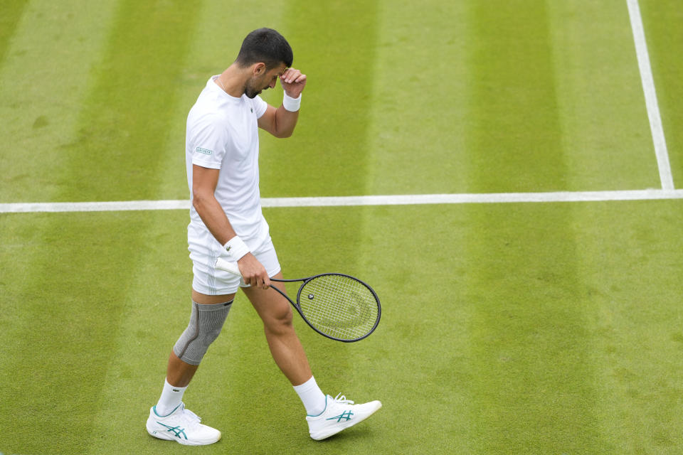 Novak Djokovic of Serbia wipes his face during a training session on Court 2 at the All England Lawn Tennis and Croquet Club in Wimbledon, London, Friday, June 28, 2024. The Wimbledon Championships begin on July 1. (AP Photo/Kirsty Wigglesworth)